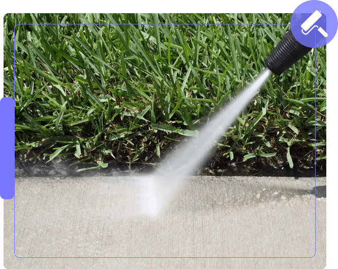 A hose spraying water on the ground near grass.